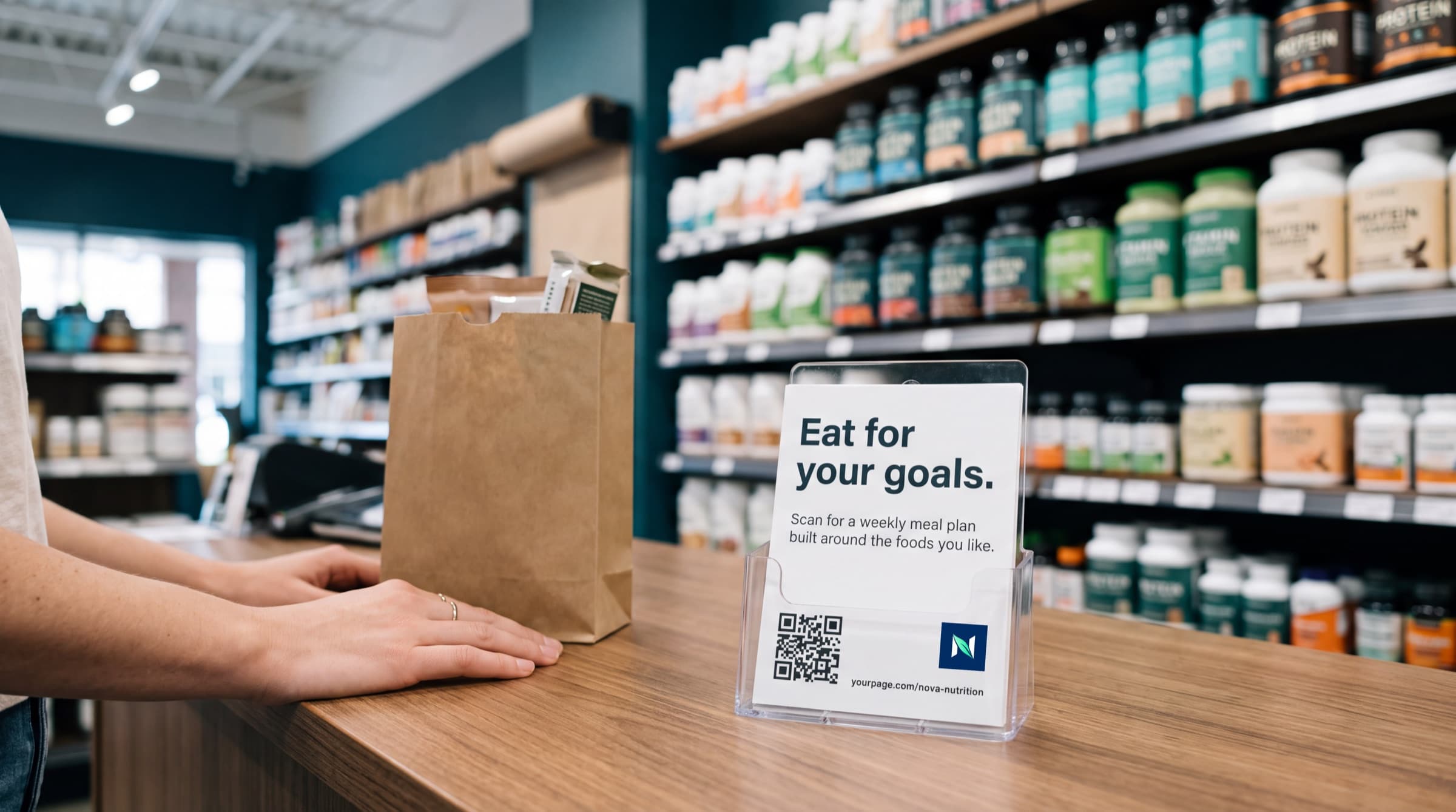 A shop counter with a branded meal plan card beside a paper bag
